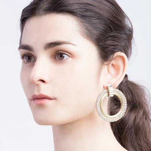 Disco-inspired fashion jewelry earrings in Gold brass and cubic zirconia